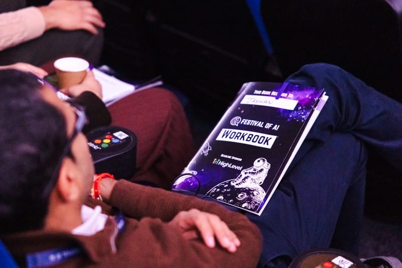An attendee with the Festival of AI 2026 workbook